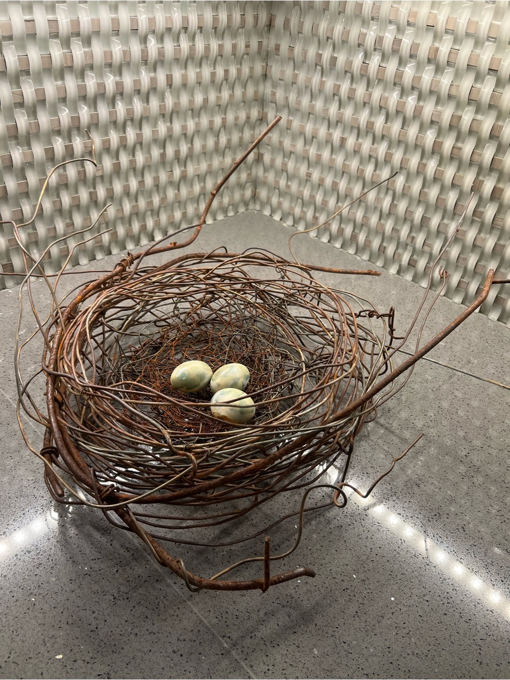Metal rustic twig nest containing three artificial eggs decorative art
